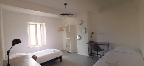 מיטה או מיטות בחדר ב-Appartement Béziers