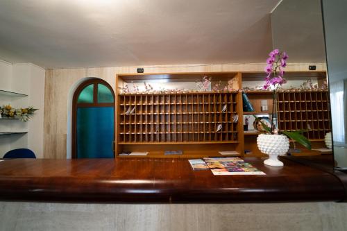 a room with a wooden desk and a book shelf at Hotel San Pietro in Letojanni