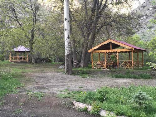 two wooden gazebos in a field with trees at Old Jermuk 