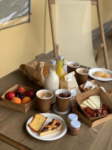 a table with plates of food and cups of milk at Castello di Serragiumenta in Firmo