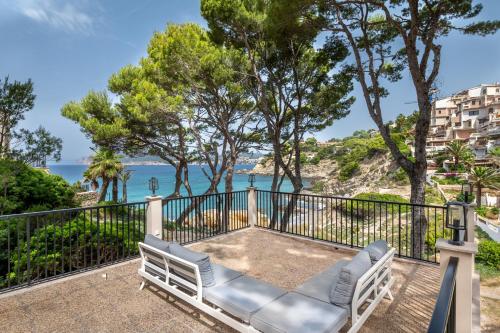 a balcony with a bench and a view of the ocean at Villa Rivo - Costa de la Calma in Costa de la Calma