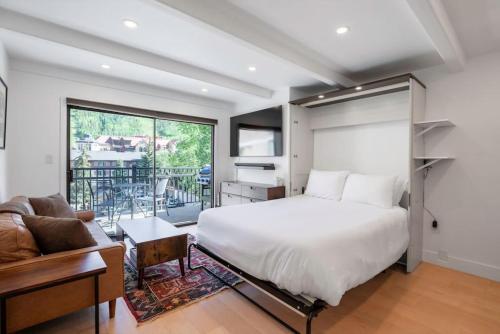 韋爾的住宿－Epic Lionshead Views, Sleeps 4，一间卧室配有一张床、一张桌子和一张沙发