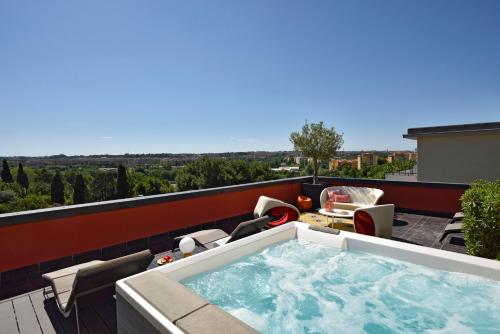a hot tub on the balcony of a house at Hotel Pulitzer in Rome