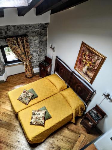 a bedroom with a yellow bed in a room at Eremo Gioioso in Pontremoli