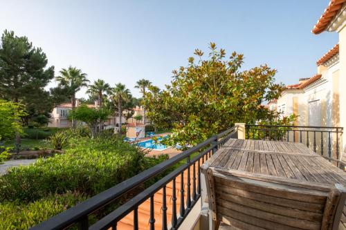 a balcony with a view of a pool and trees at Fantastic T3 Sebastião in Casal da Lagoa Seca