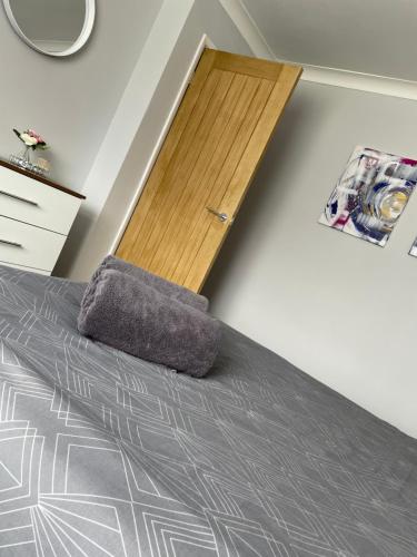 a bedroom with a bed and a wooden door at Ancaster Apartments in Brumby