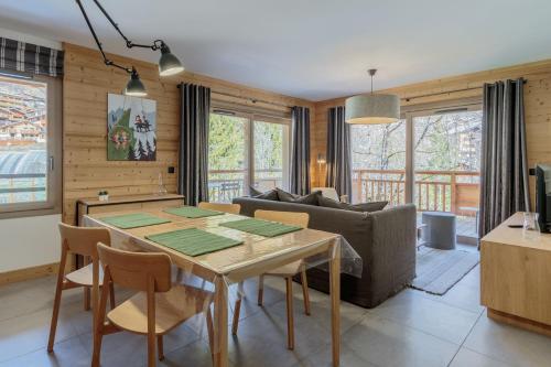 uma sala de estar com uma mesa e um sofá em Les Terrasses de la Vanoise em Champagny-en-Vanoise