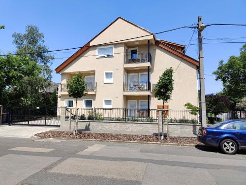 a building with a car parked in front of it at Paskal-Lux Apartments with Free Parking and AC in Budapest