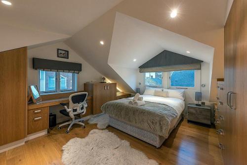 a bedroom with a bed and a desk with a computer at NEW Stunning 5BD Mews House in London