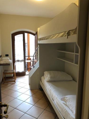 a bedroom with a bunk bed and a table at Casa Mary apartments in Tignale