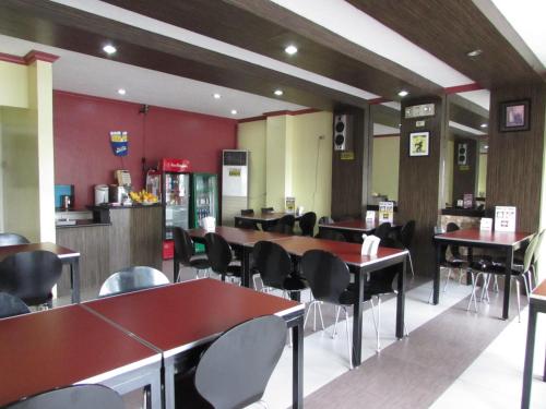 a dining room with tables and chairs in a restaurant at Oyster Plaza Hotel in Manila