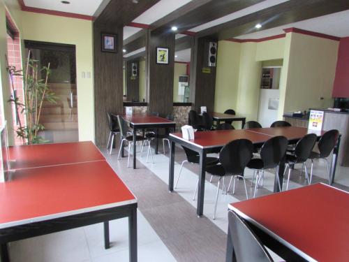 a dining room with red tables and chairs at Oyster Plaza Hotel in Manila