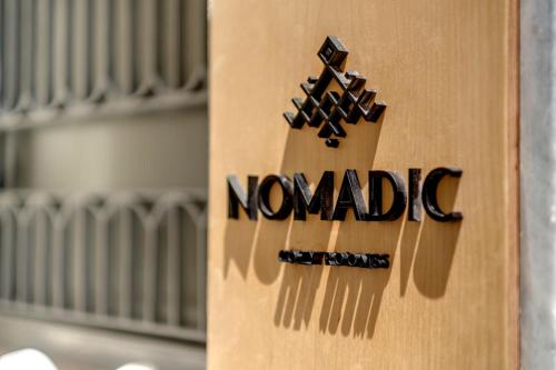 a wooden guitar with the word nomadic on it at Nomadic Cozy Rooms in Ermoupoli