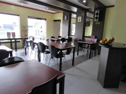 a dining room with tables and chairs in a restaurant at Oyster Plaza Hotel in Manila