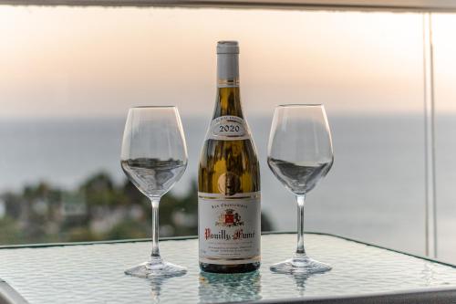 a bottle of wine and two wine glasses on a table at CASA BIANCA & Spa 2 in Ulcinj