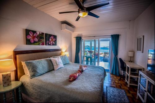 a bedroom with a bed with a stuffed animal on it at Beautiful Honeymoon Suite at Sunset Serenade in Enighed