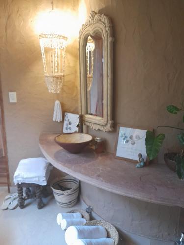 a bathroom with a sink and a mirror at Satori Zen Club in Itauguá