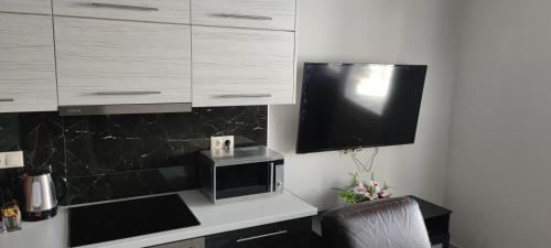 A television and/or entertainment center at Maxim Deluxe Apartment