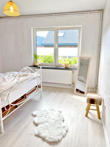 a bedroom with a white bed and a window at Residence Stay Eva Upstairs Brunch Café in Ghent