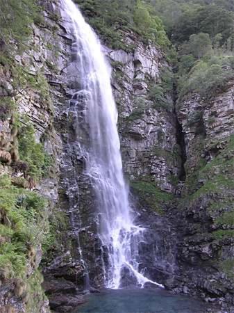 a waterfall on the side of a rocky mountain at Appartamento N. 6 Casa Betulla in Sonogno