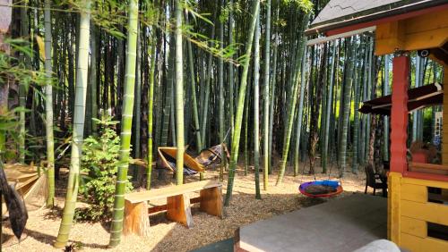 a dog laying in a hammock in a bamboo forest at あかがね荘 in Sumino