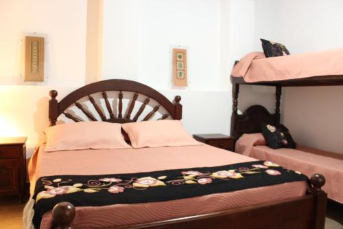 a bedroom with a bed and two bunk beds at Finca Santa Rita in Corralito