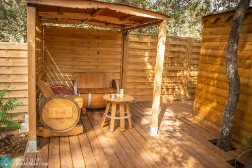 a wooden deck with a chair and a table at Interlude in Lambesc