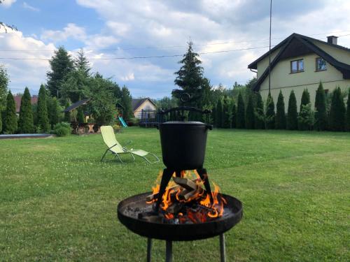 a pot on top of a fire in a yard at Dom Wypoczynkowy U Kasi in Jurgów