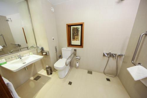 a bathroom with a toilet and a sink at Holiday Inn Tabuk by IHG in Tabuk
