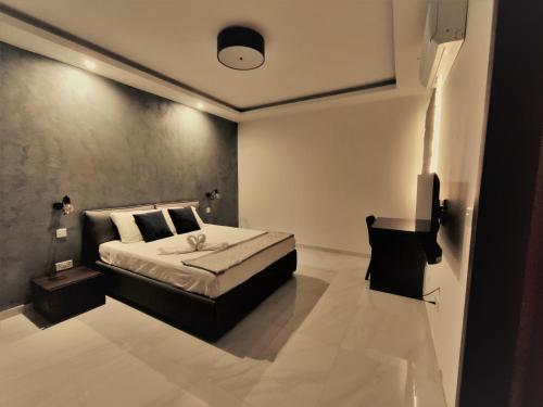 a bedroom with a bed and a television in it at SouthShore Accommodation in Marsaskala
