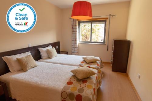 a bedroom with two beds and a sign that says clean and safe at Casa da Levada in Termas de Sao Pedro do Sul