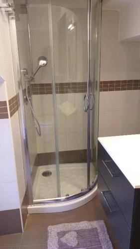 a shower with a glass door in a bathroom at Nial House in Monopoli