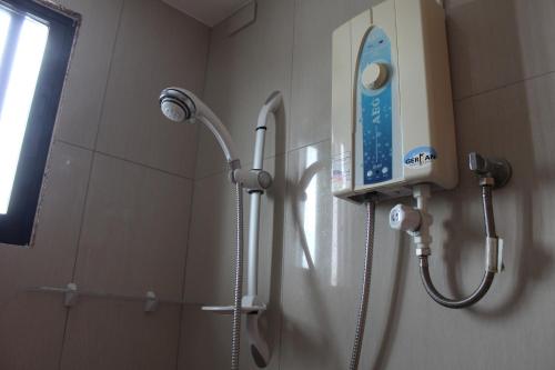 a shower in a bathroom with a blow dryer at Amigos Beach Resort in Boracay