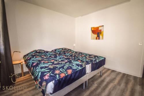 1 dormitorio con 1 cama y una pintura en la pared en Apartment A im Grünen, Mörel Breiten, en Mörel