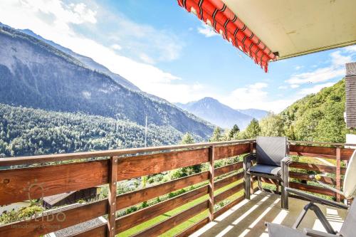 a balcony with a chair and a view of mountains at Apartment A im Grünen, Mörel Breiten in Mörel