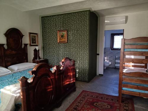 a bedroom with a wooden bed and a bathroom at Agriturismo Helianthus in Oleggio