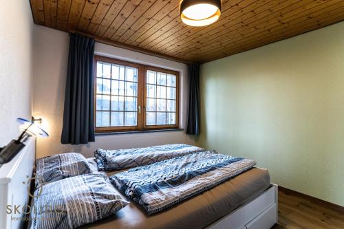 a bedroom with a bed with pillows on it at 2-Zimmerwohnung an zentraler Lage/Ski-in, Ski-out in Riederalp