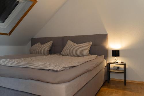 a bed with two pillows on it in a room at Ferienwohnung „ Happy Place“ Orscholz in Mettlach