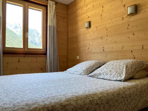 a bedroom with a bed with two pillows on it at La Saume in Ceillac