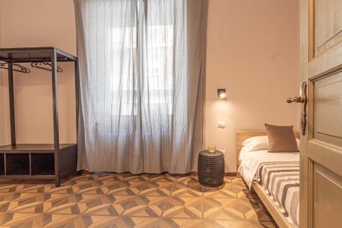 a bedroom with a bed and a large window at Galvani Apartments in Terni