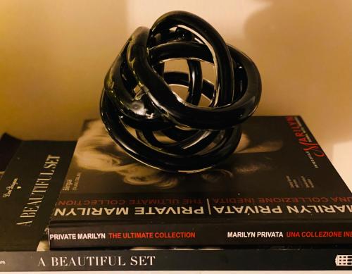 a pile of books with a ring on top of them at Adream in Pescara