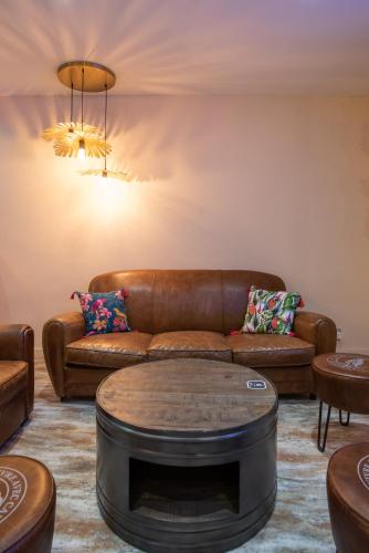 a living room with a leather couch and a coffee table at Mercure Marseille Centre Vieux Port in Marseille