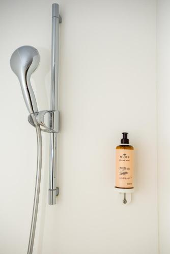 a shower with a bottle of soap on a wall at Mercure Marseille Centre Vieux Port in Marseille