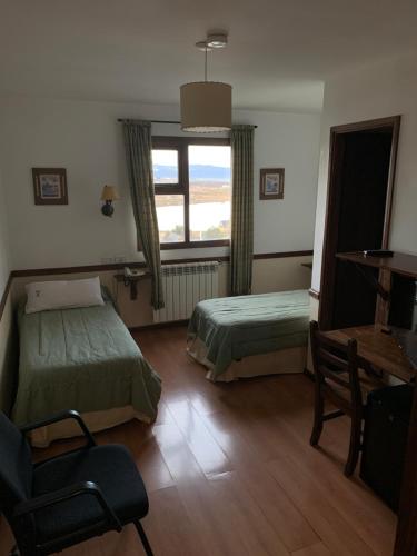 Ένα ή περισσότερα κρεβάτια σε δωμάτιο στο Hosteria Sloggett