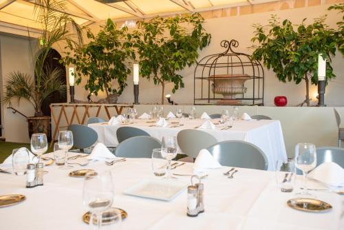 a room with tables and chairs with a bird cage at Mercure Marseille Centre Vieux Port in Marseille