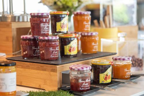 a bunch of jars of jam on a shelf at Mercure Marseille Centre Vieux Port in Marseille