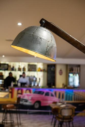 a light in a restaurant with a pink truck at Mercure Marseille Centre Vieux Port in Marseille
