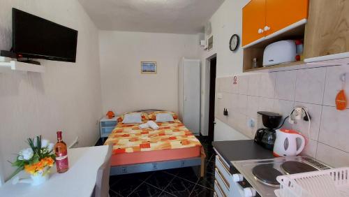 a small kitchen with a bed in a small room at Dalibor in Senj