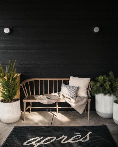 a wooden bench in a room with two potted plants at Apres Whitefish in Whitefish
