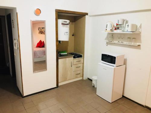 a small kitchen with a sink and a microwave at Departamento céntrico ciudad Mendoza in Mendoza